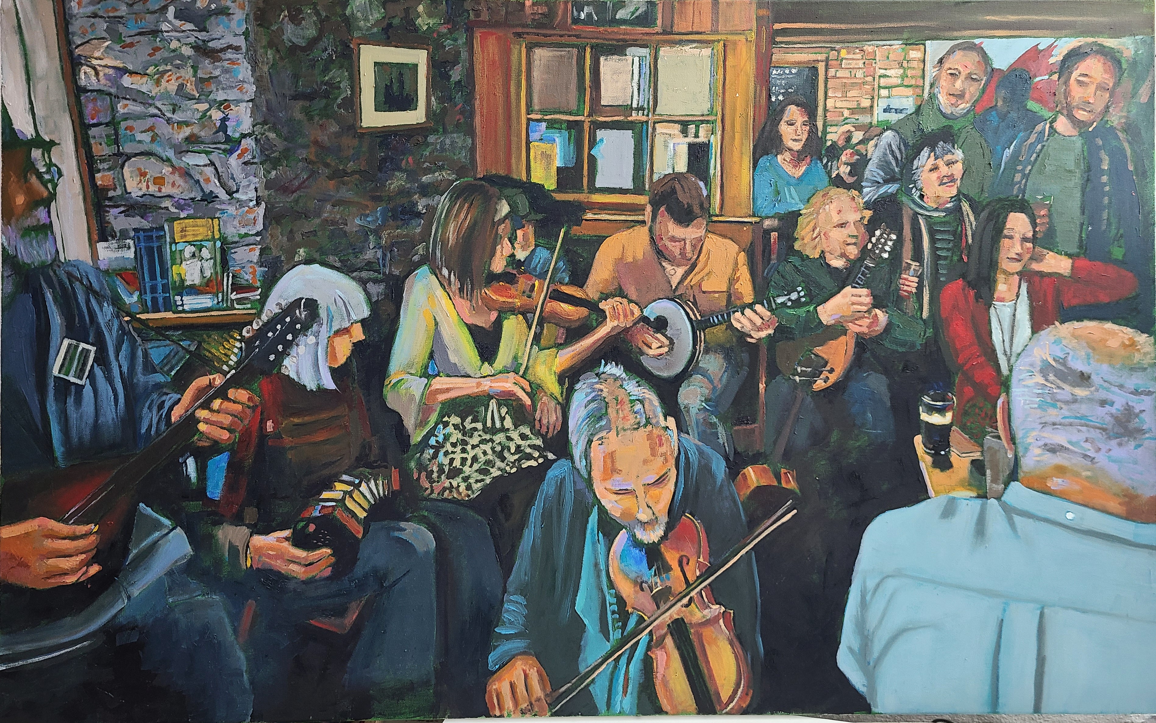 A group of folk musicians with banjoes, violins and squeeze boxes enjoying a night out at a pub.